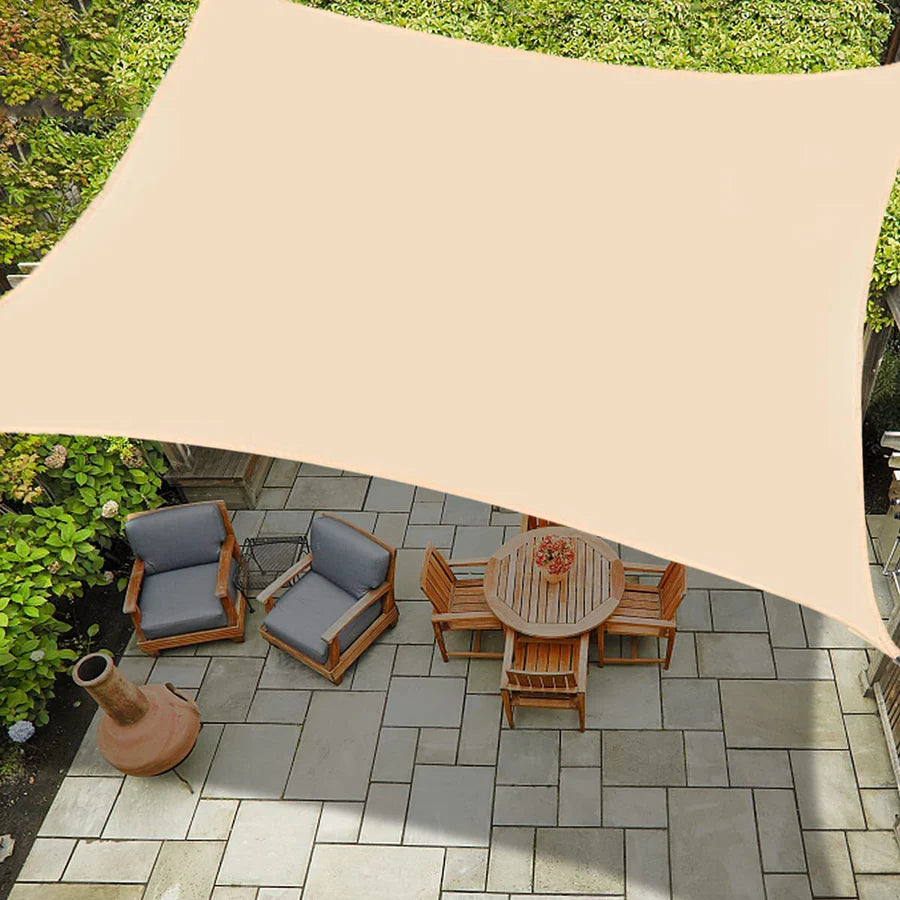 Beige outdoor waterproof rectangle sun shade sail canopy extends over a patio with dining set, offering sun/rain protection.