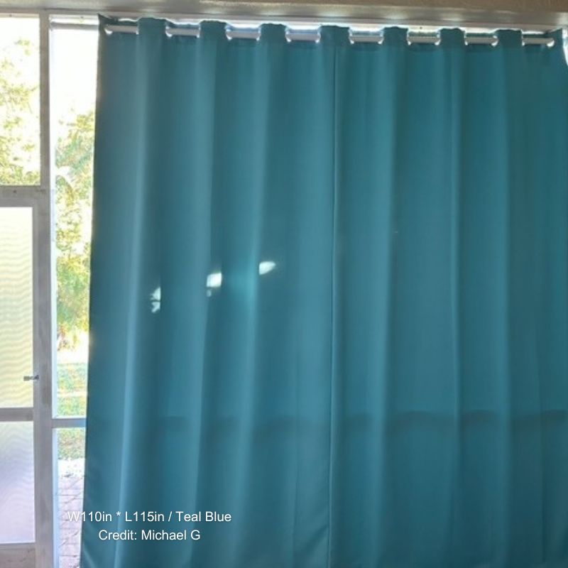 Teal blue waterproof grommet top outdoor curtain panel on a patio door, providing sun protection and privacy.