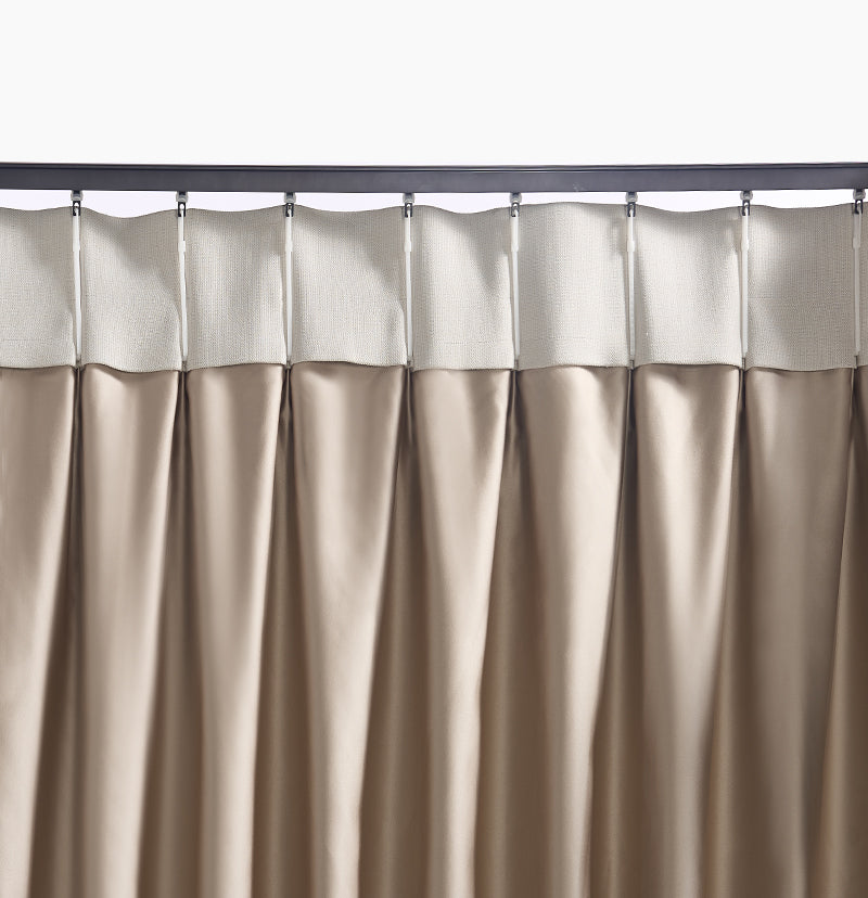 Custom heavy-duty metal curtain track with curtain glides supporting a pleated beige outdoor privacy curtain.