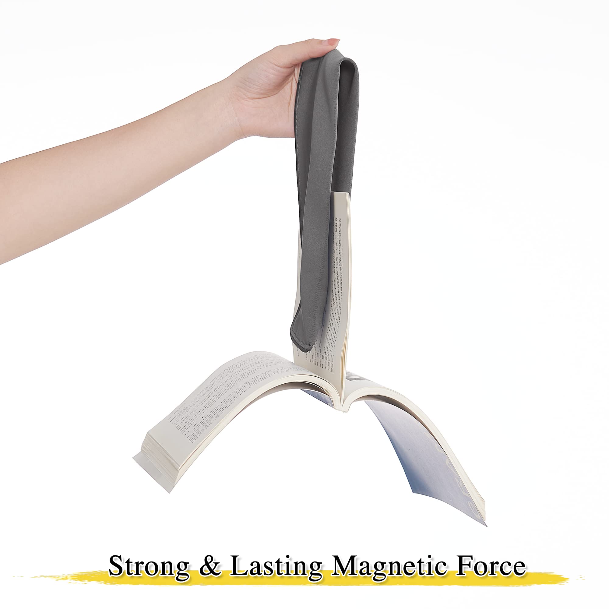 Hand demonstrating a gray magnetic decorative drape tie-back securely gripping an open book, highlighting its strong, lasting magnetic force.