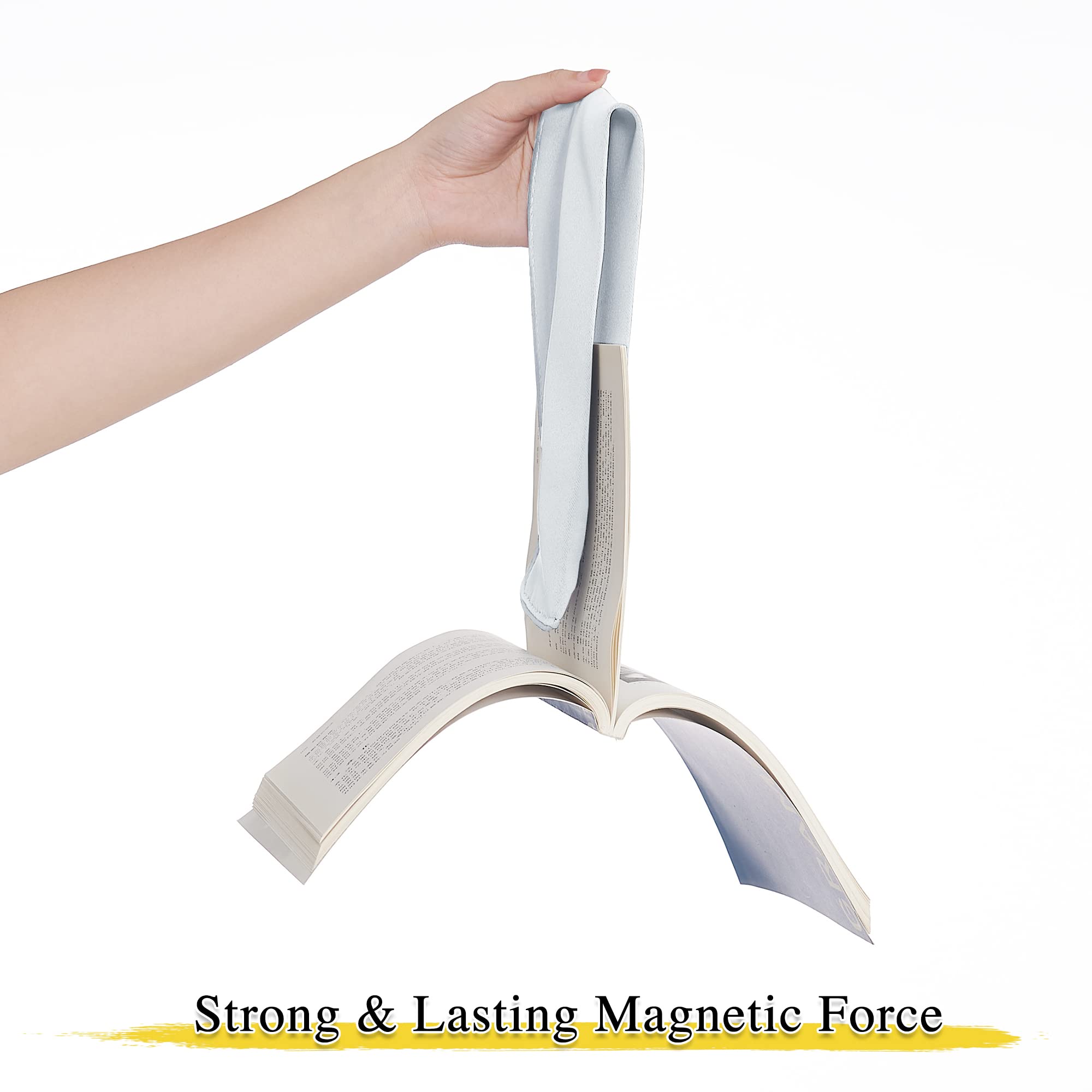 Hand holding a light blue decorative drape tie back, magnetically suspending an open book to demonstrate strong, lasting magnetic force.