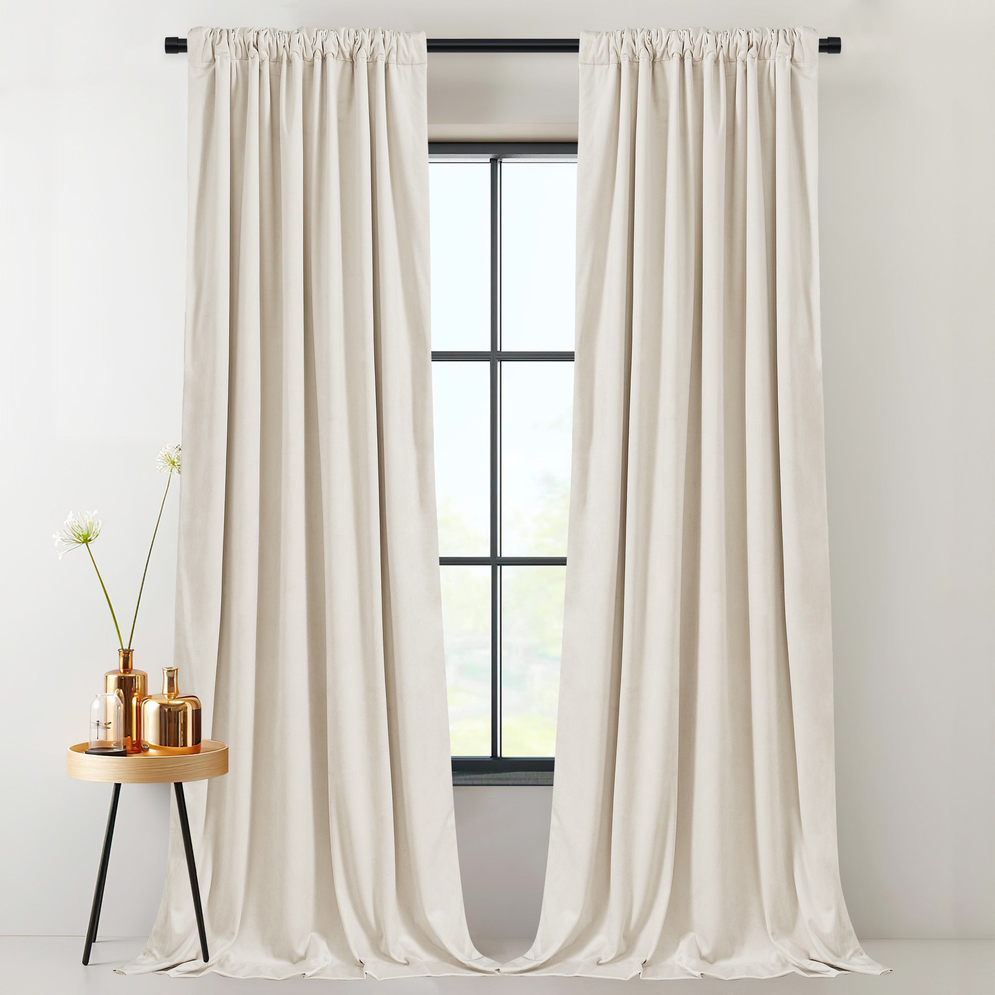 Pair of thick cream velvet light blocking & thermal insulated rod pocket drapes, pulled open to reveal a window.
