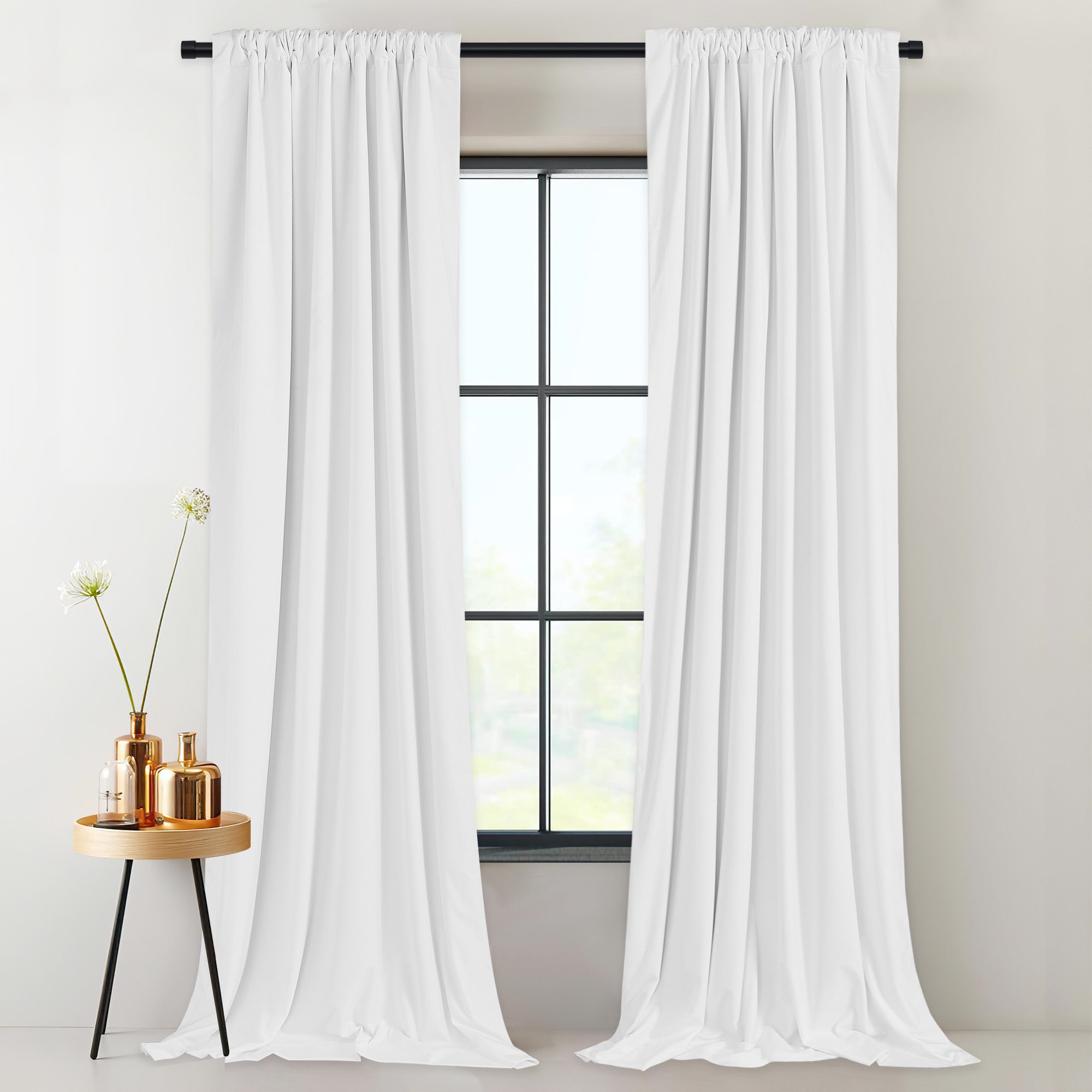 Elegant white velvet thermal insulated, light blocking drapes with rod pocket/back tab styling framing a sunlit window.