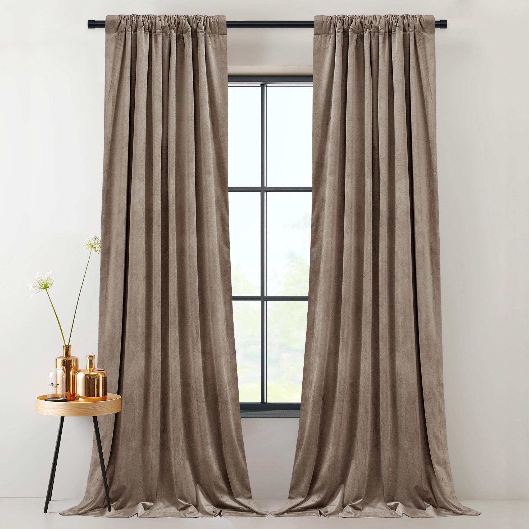 Luxurious taupe velvet 2-layer thermal insulated light blocking drapes. Thick rod pocket curtains styled elegantly by a window.
