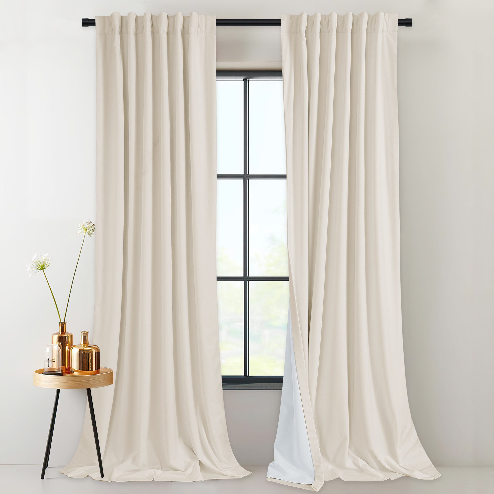 Light beige 2-layer velvet thermal insulated light blocking curtains with rod pocket & back tab. Thick drapes frame a modern window.