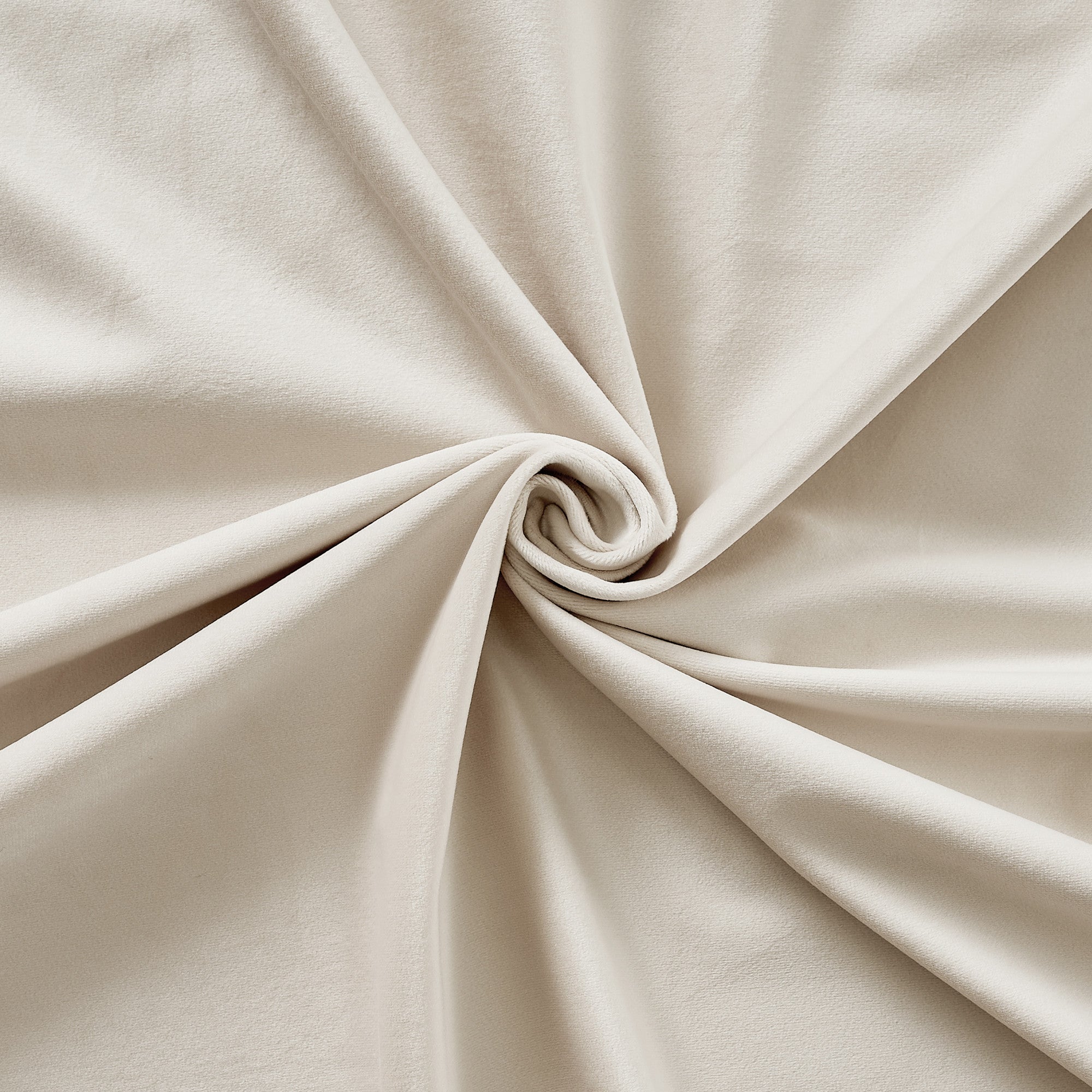 Close-up of soft, creamy velvet fabric swirled to showcase its thick, light-blocking and thermal-insulated drapes material.