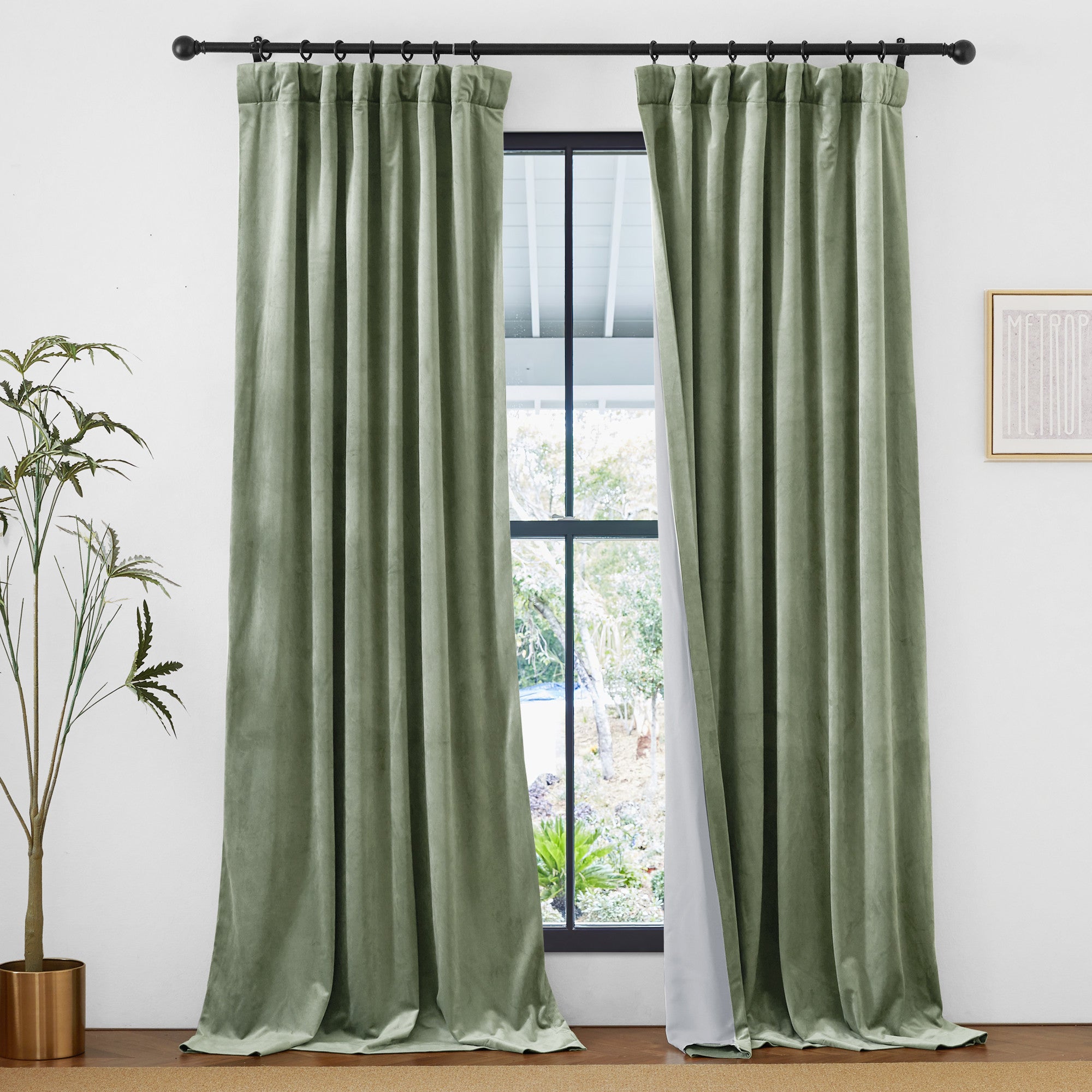 Sage green velvet thermal insulated 2-layer light blocking curtains with rod pocket & back tab, partly open on window.