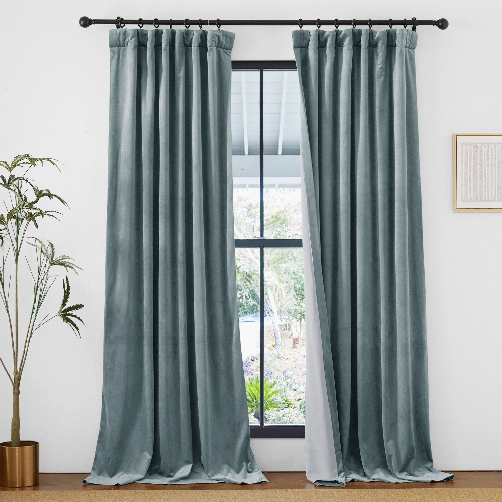 Thick teal velvet 2-layer thermal insulated light blocking drapes with rod pocket & back tab, framing an outdoor view.