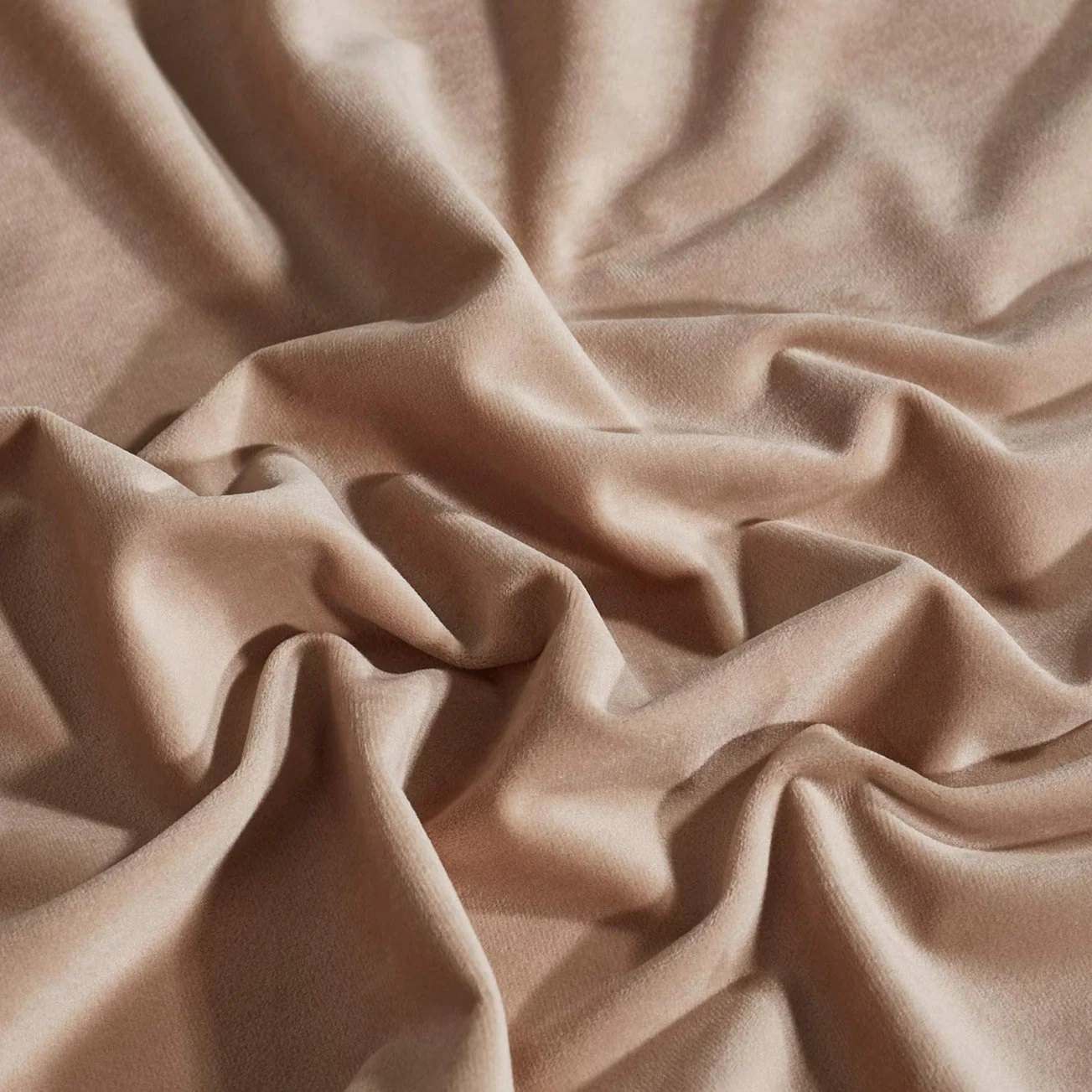Luxurious beige velvet fabric sample draped, highlighting soft texture and rich color for KGORGE custom curtains.