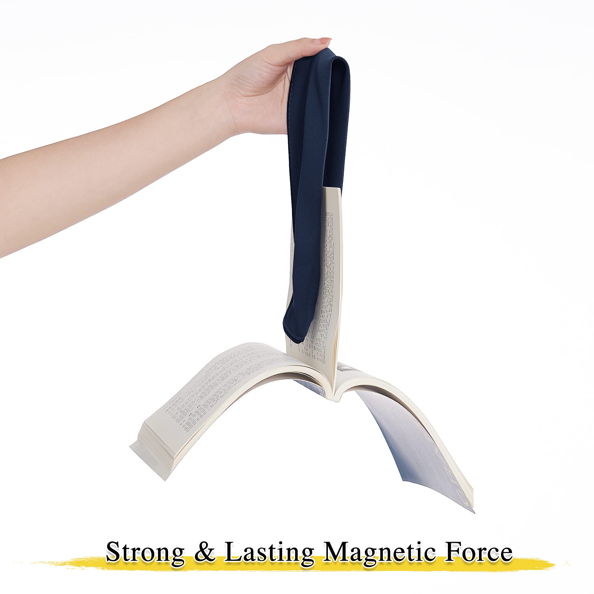Hand holding a navy magnetic curtain tie back suspending an open book, demonstrating strong & lasting magnetic force.