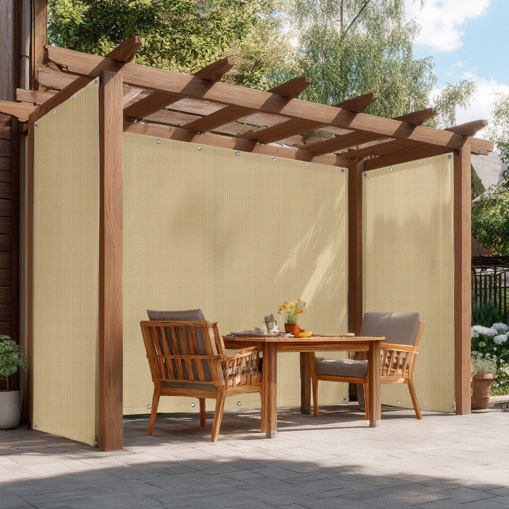 Light beige outdoor HDPE breathable mesh tarps with grommets providing sun protection and privacy on a patio pergola.