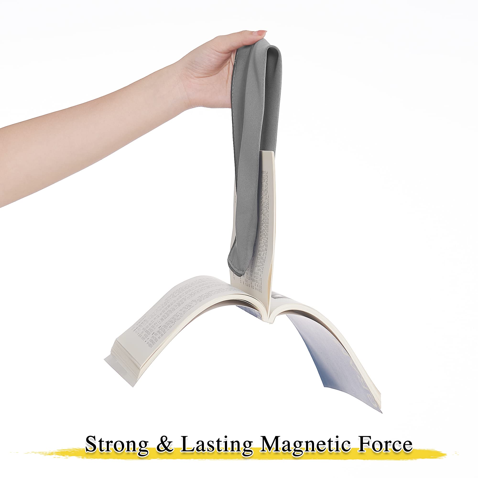 Hand holding a gray magnetic drape tie back suspending an open book, demonstrating the strong lasting magnetic force of the curtain tie backs.
