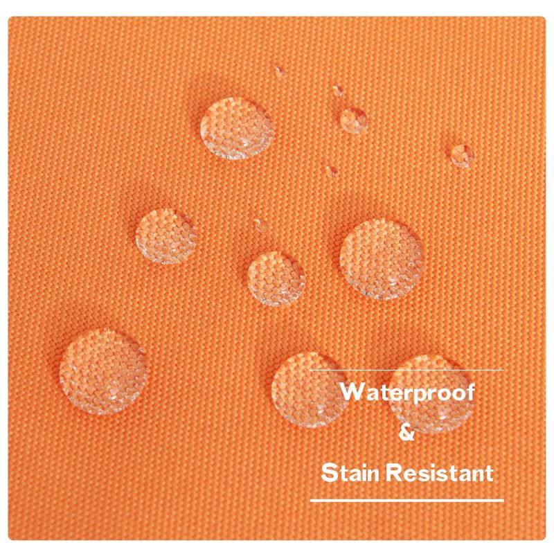 Close-up of orange outdoor canvas fabric with water beading, demonstrating its waterproof and stain-resistant properties for patios