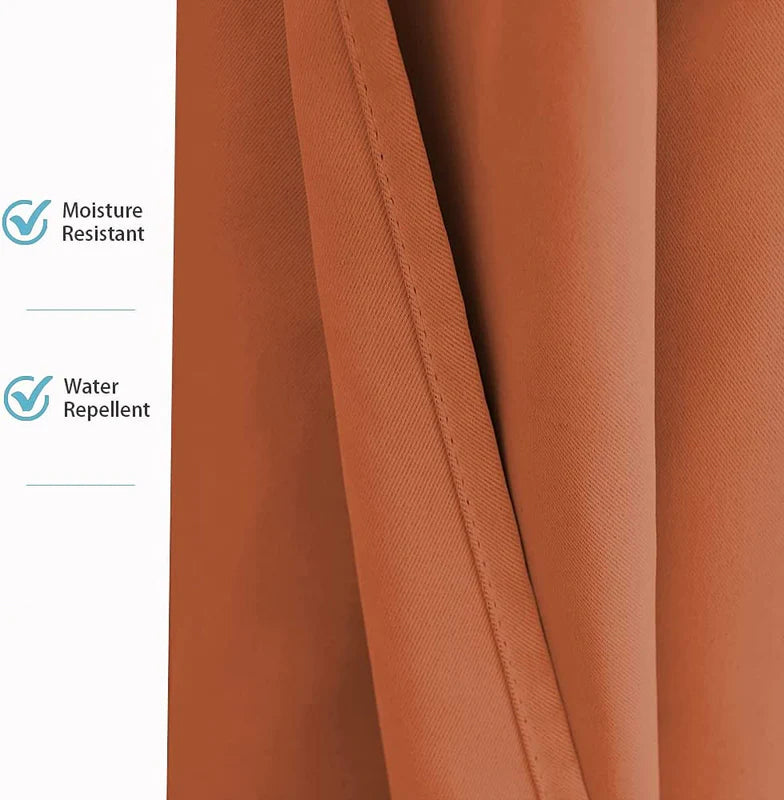Close-up of rust-orange weatherproof patio outdoor curtain fabric, highlighting its moisture resistant and water repellent properties.