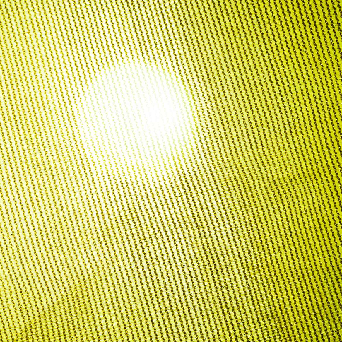 Close-up of bright yellow breathable HDPE sun shade sail fabric texture, highlighting the UV block mesh weave with sunlight.