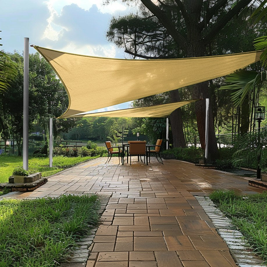 Two beige breathable triangle sun shade sails providing UV block over a patio dining area, perfect for outdoor living.