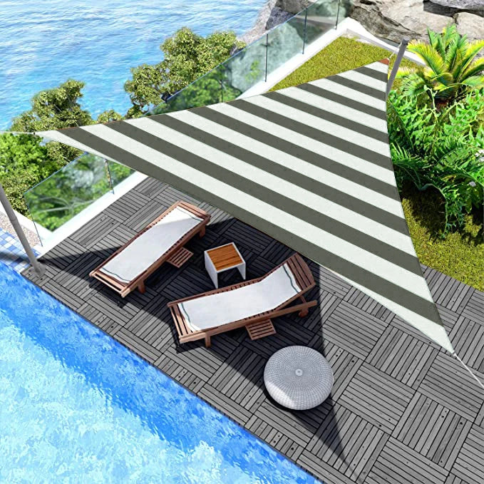 KGORGE outdoor waterproof striped triangle sun shade sail providing UV block & opaque privacy over a pool patio with lounge chairs.