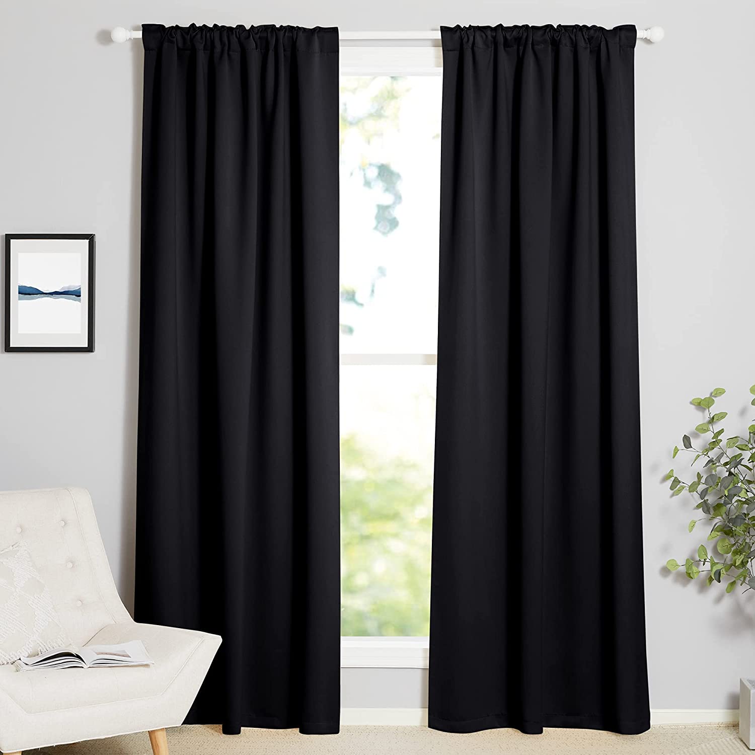 Two black rod pocket & back tab thermal insulated blackout curtains fully drawn over a window for living room or bedroom.