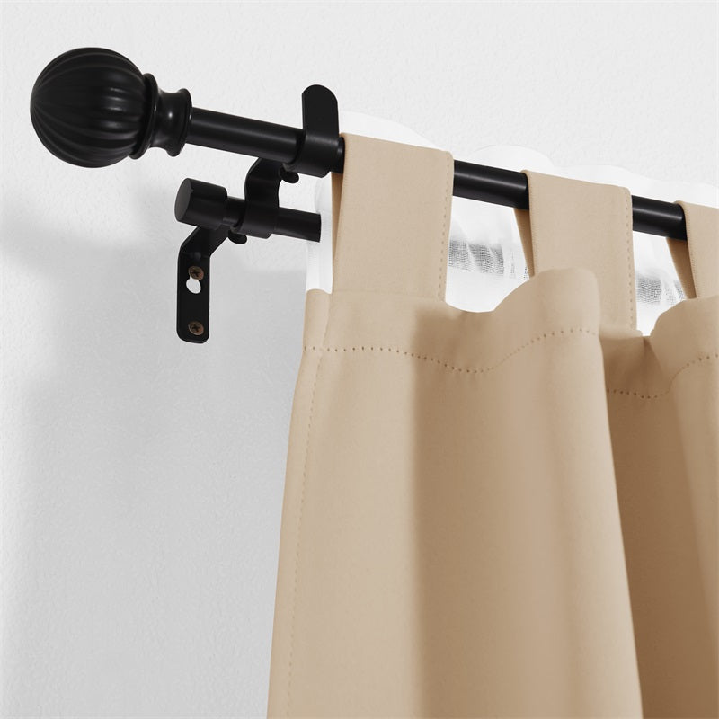 Close-up of black 1-inch ball telescoping double outdoor curtain rod with beige tab-top curtain and sheer white drape