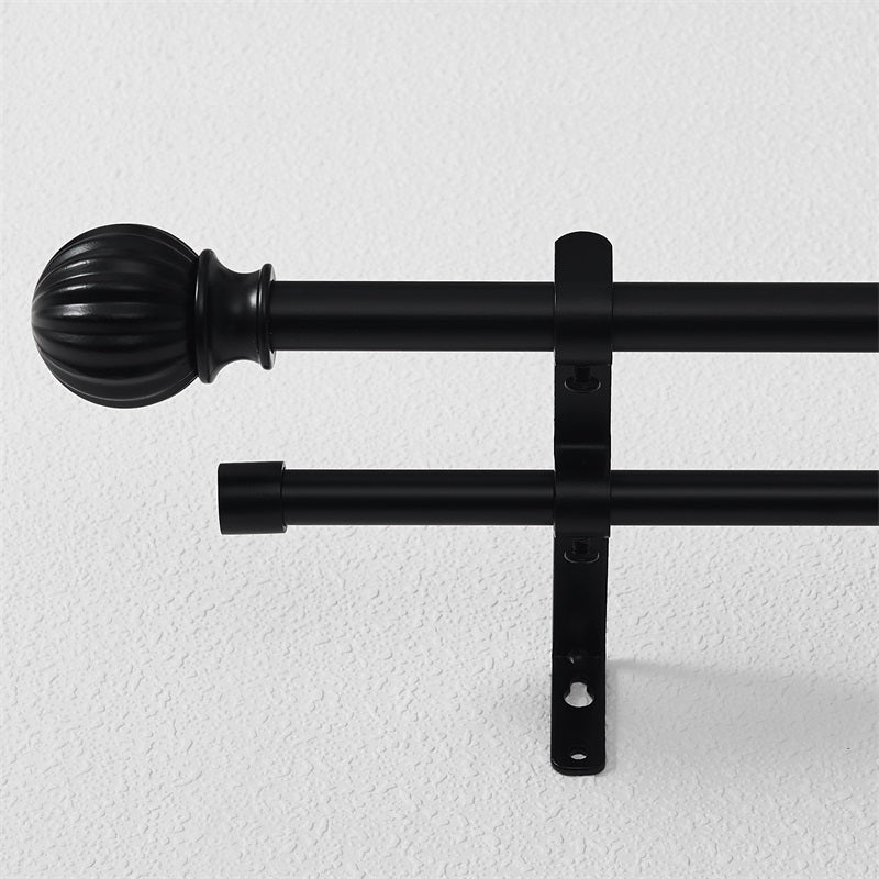Close-up of black 1 inch ball telescoping double outdoor curtain rod set with fluted finial & bracket on white wall.