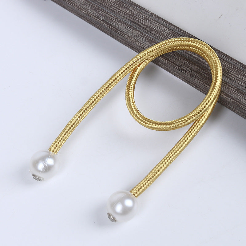 Gold braided rope with magnetic pearl ball ends, designed as a stylish curtain tieback for indoor or outdoor drapes.