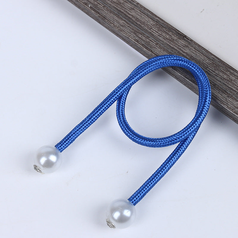 Blue braided magnetic curtain tieback with two white pearl balls, designed to stylishly secure outdoor shade curtains.