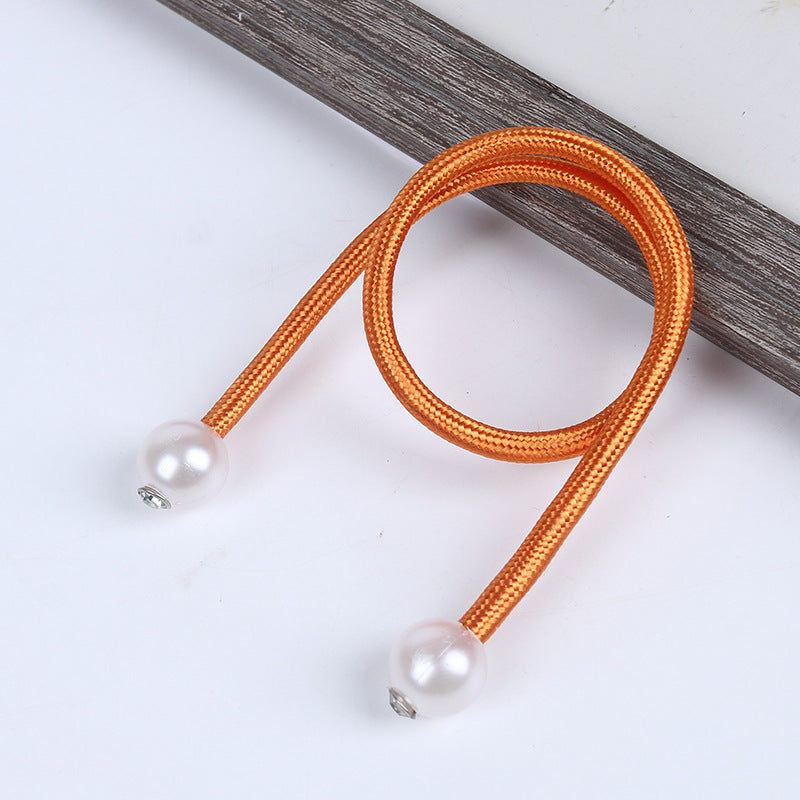 Vibrant orange braided magnetic curtain tieback strap with two elegant pearl balls, perfect for outdoor privacy curtains.
