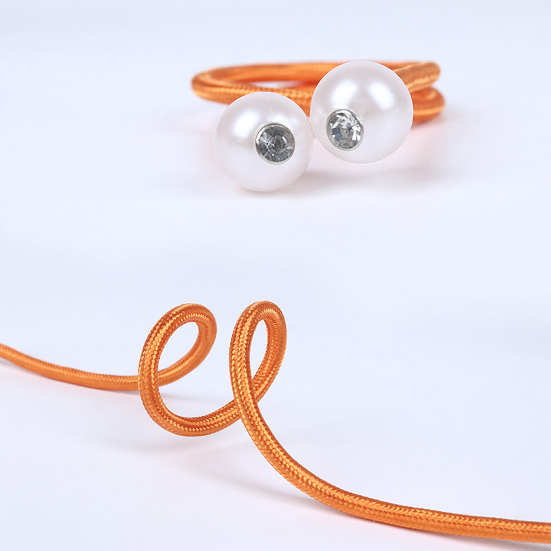 Orange braided magnetic curtain tieback with two white pearl balls and sparkling clear gems, perfect for outdoor patio curtains.