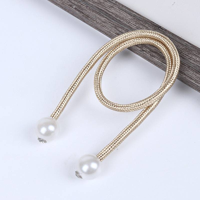 Stylish gold braided magnetic curtain tieback strap with pearl balls and crystal details, perfect for outdoor curtains.