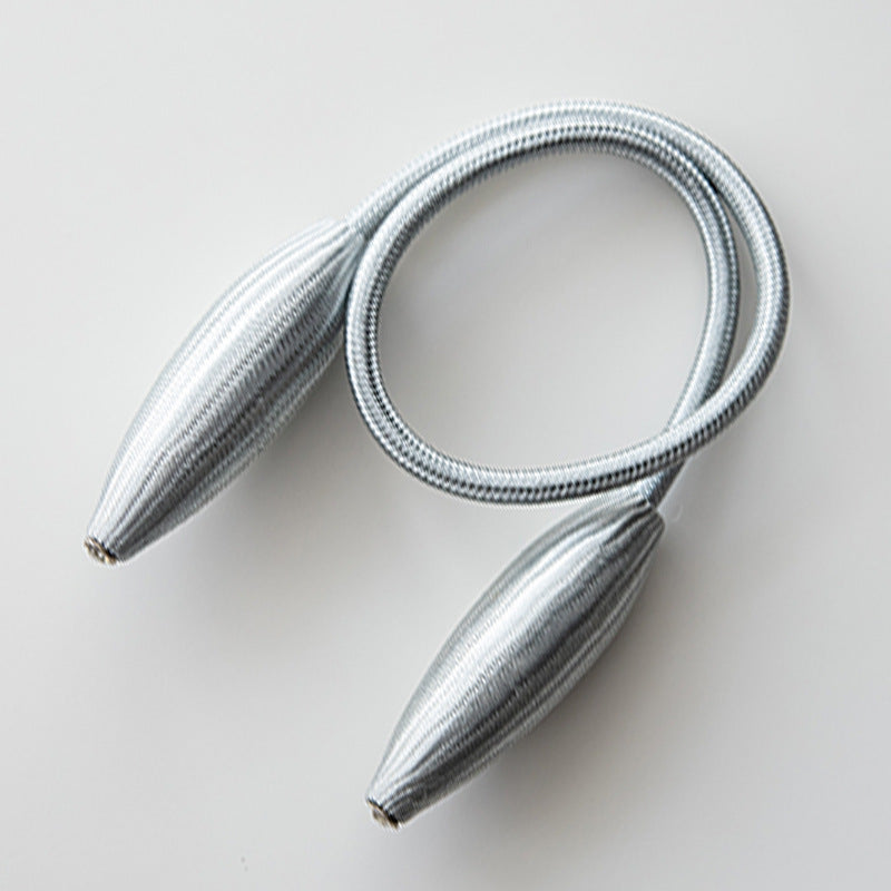 Simple modern silver braided curtain tieback strap with sleek tapered ends. Flexible buckle curtain accessory.