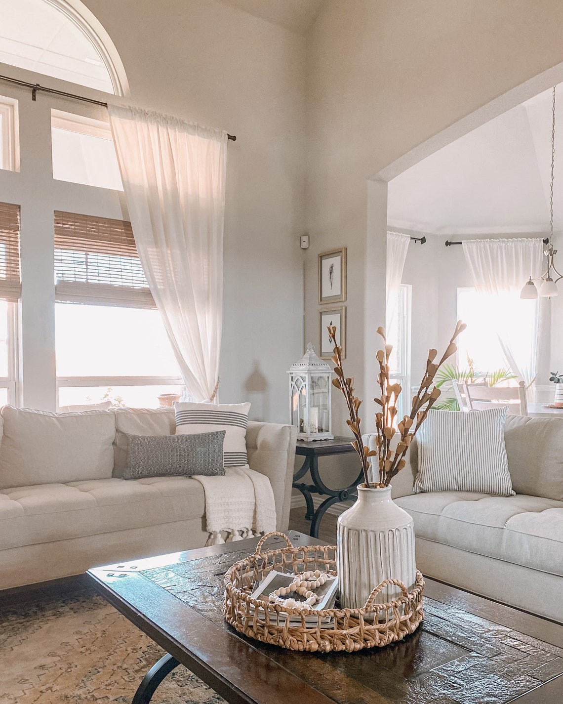 Cozy living room with sheer white window curtains. Decorative wooden beads, perfect as curtain tieback straps, displayed in a basket.