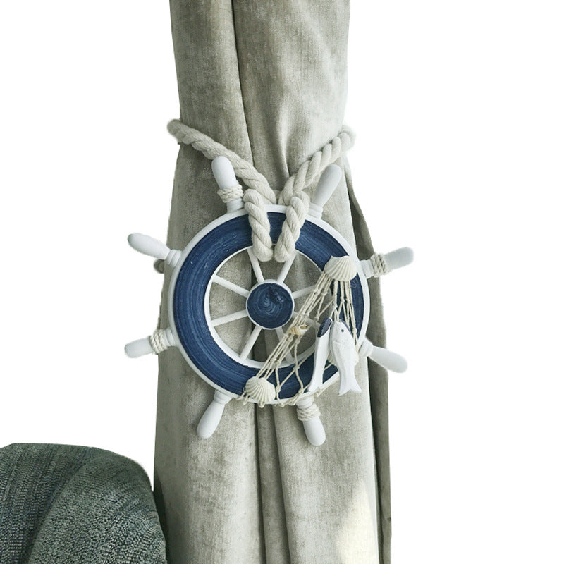 Nautical ship wheel curtain tieback & holder strap with woven rope, seashells, fish, bundling a beige curtain.