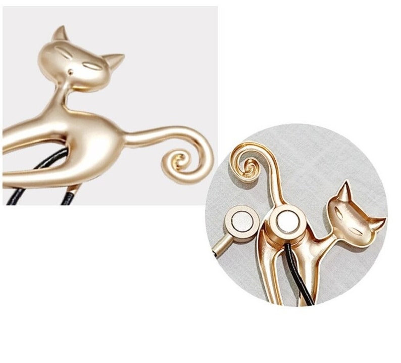 Gold cat magnetic curtain tieback with a playful design, coiled tail, and visible magnets, ideal for securing outdoor curtains.