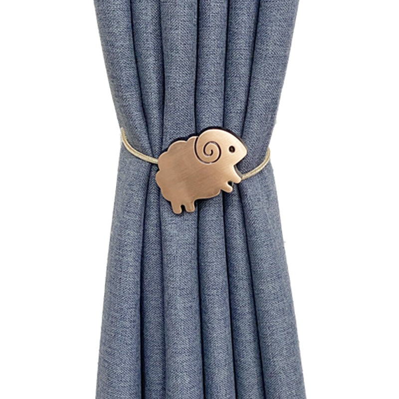Bronze sheep shaped magnetic curtain tieback securing a pleated blue fade-resistant outdoor curtain
