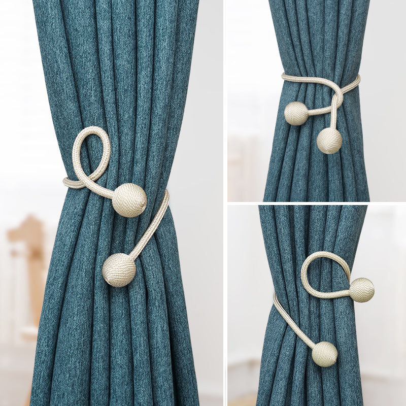 Kgorge beige simple & modern rope curtain tieback with sphere ends, securing a blue outdoor patio curtain. Versatile styling.