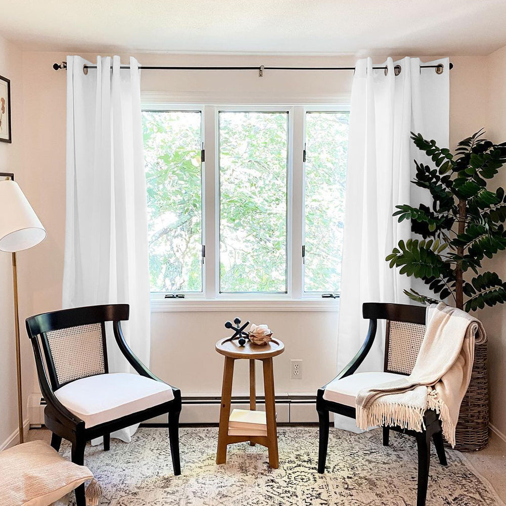 White grommet thermal insulated blackout weave curtains (2 panels) frame a living room window with trees outside.