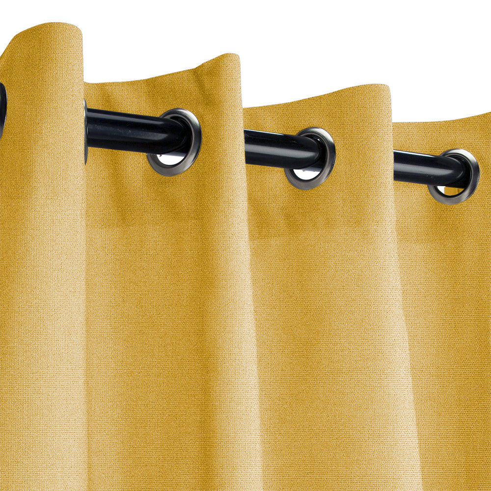 Close-up of golden yellow KGORGE Fadenomore outdoor curtain fabric with black grommets on a rod, showcasing fade-resistant material.