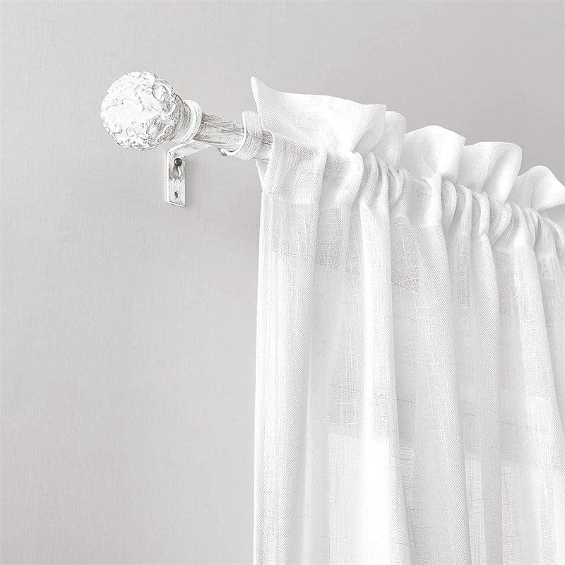 Close-up of white distressed extra-long outdoor curtain rod with decorative petal ball cap, holding a sheer white weatherproof curtain.