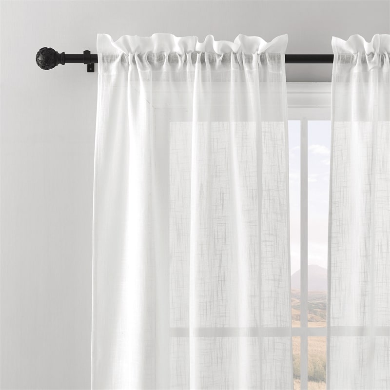 Adjustable extra-long outdoor curtain rod with decorative black petal ball finials holding white sheer weatherproof outdoor curtains.