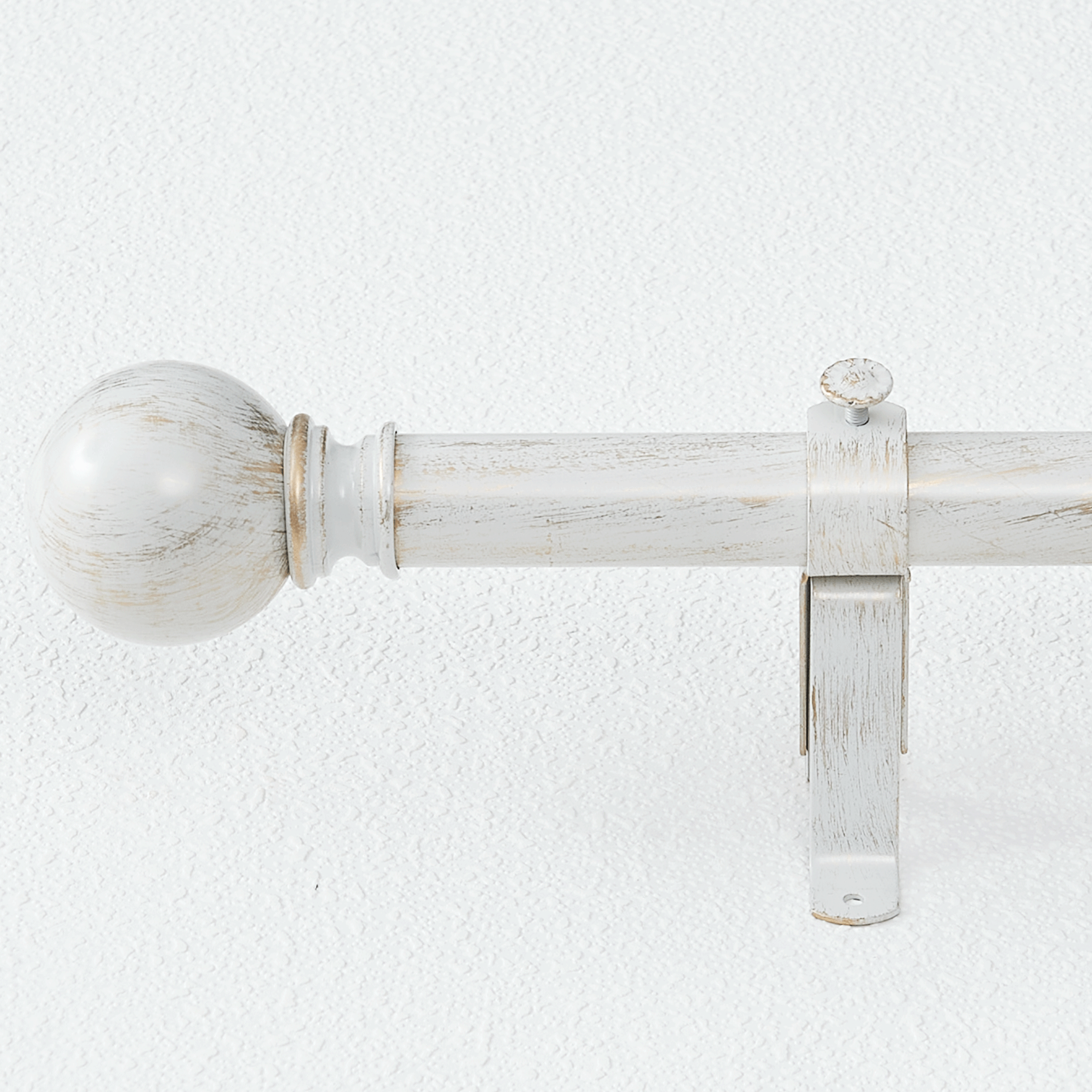 Distressed antique white aluminum alloy decorative curtain rod with ball finial for outdoor & indoor use, mounted to wall.