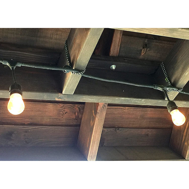 Heavy-duty ball bungee cords securing outdoor string lights to wooden pergola beams for versatile organization.