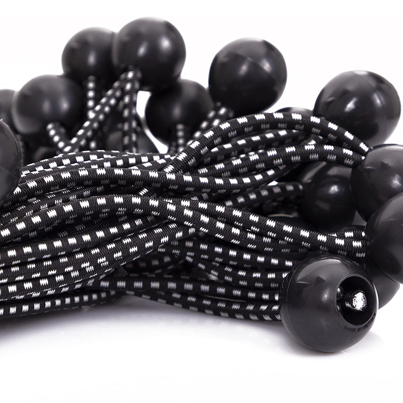 Close-up of multiple heavy-duty black ball bungee cords with a white dotted pattern, perfect for outdoor tarp tie-downs & securing.