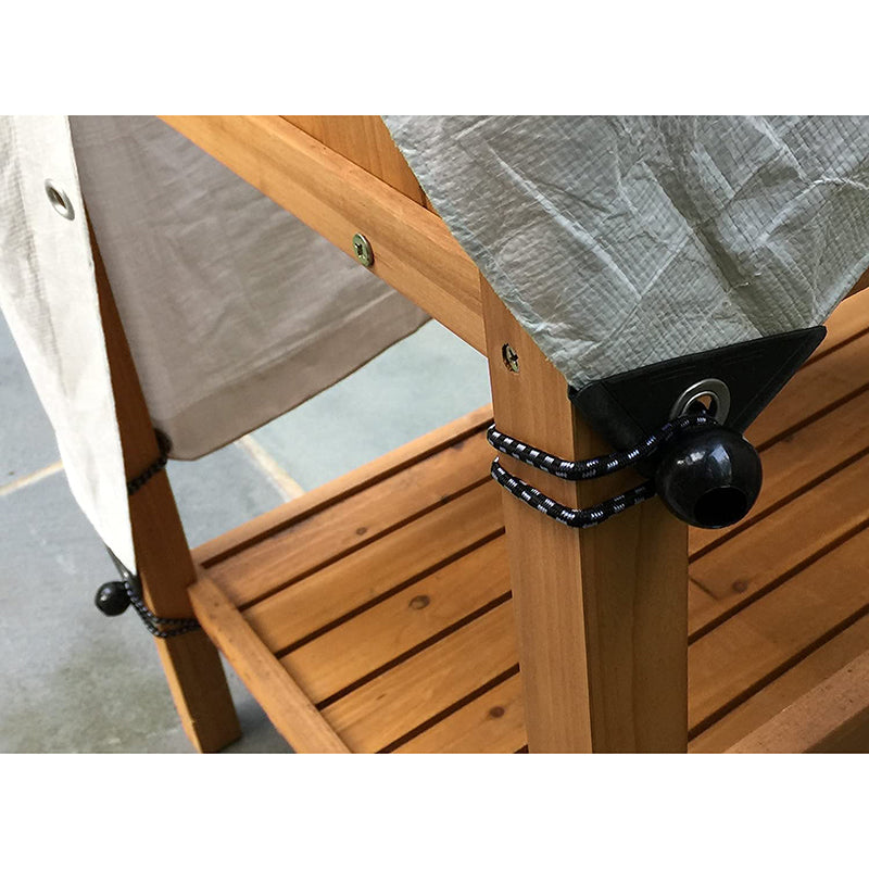Ball bungee cords securing a gray outdoor tarp & beige fabric to a wooden pergola post for versatile tarp tie-down.