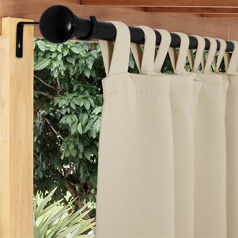 Black rust-resistant outdoor curtain rod mounted on a wooden beam, holding a beige tab-top outdoor curtain.