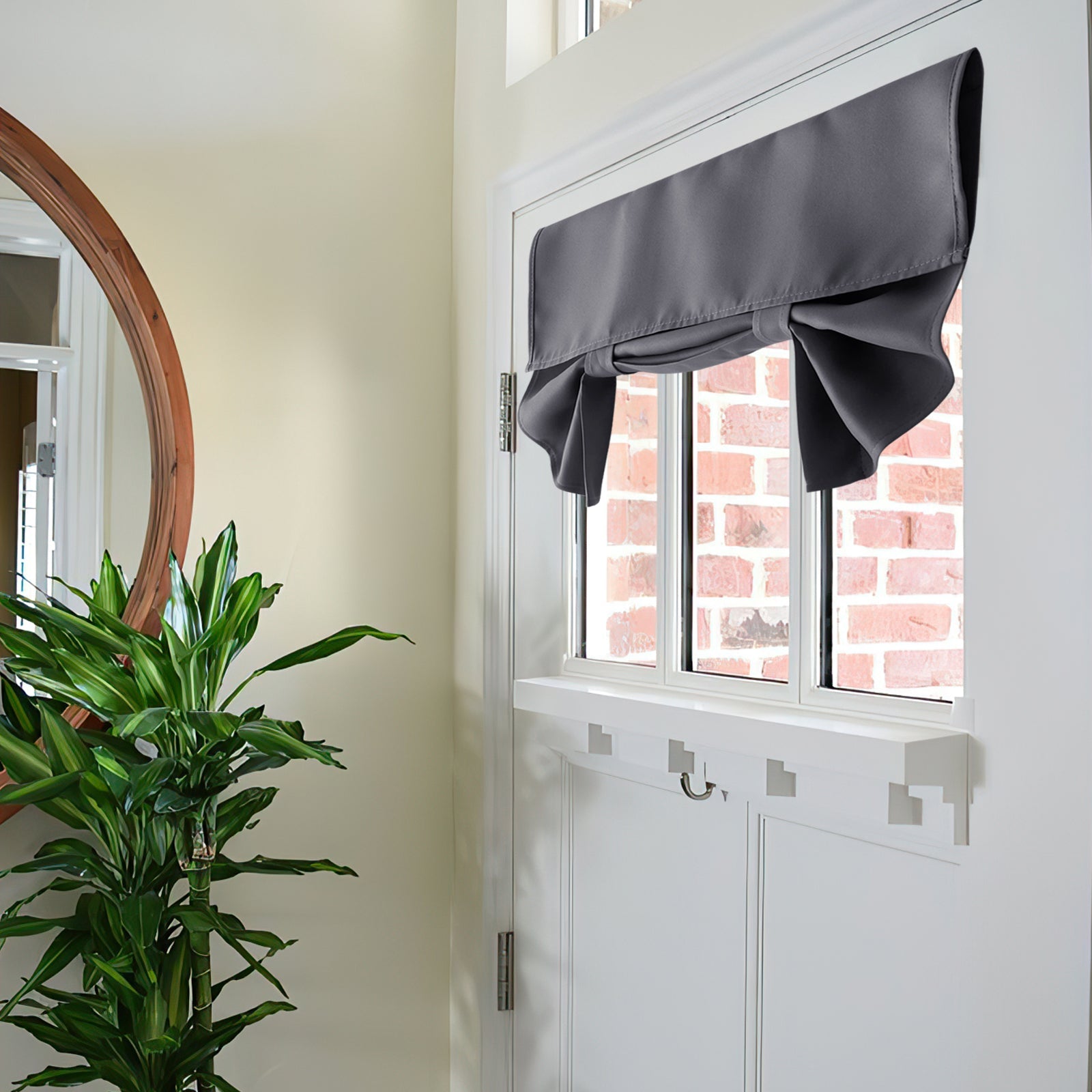 Gray faux linen tie-up blackout privacy curtain styled on a white French door. Offers coverage for patio door windows, brick background.