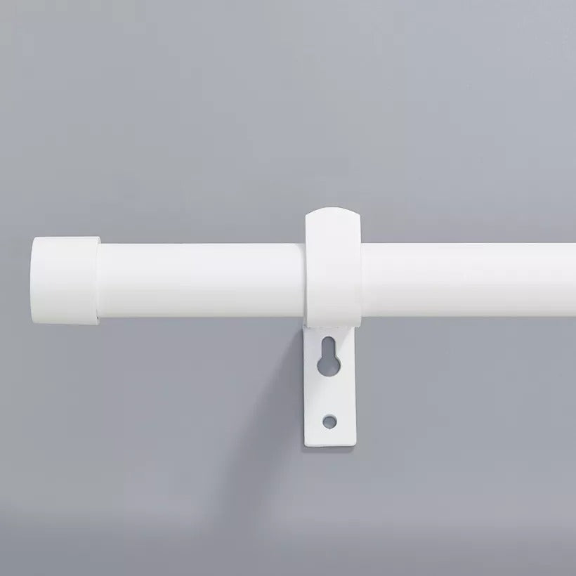 White brushed finial indoor/outdoor curtain rod with a white mounting bracket against a grey wall