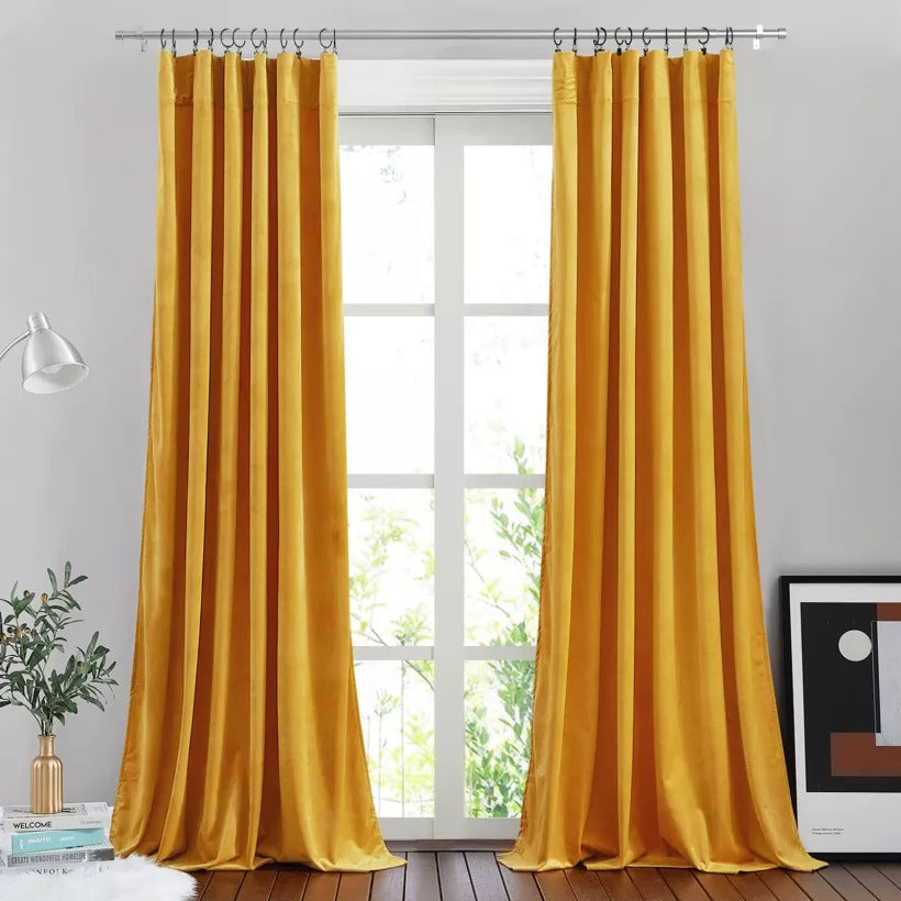 Brushed finial indoor/outdoor curtain rod in silver finish, showcasing its sturdy design holding flowing yellow curtains.