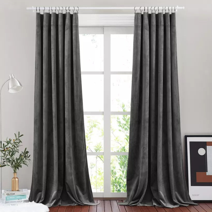 White brushed finial indoor/outdoor curtain rods displaying dark grey curtains over a bright window in a modern room.