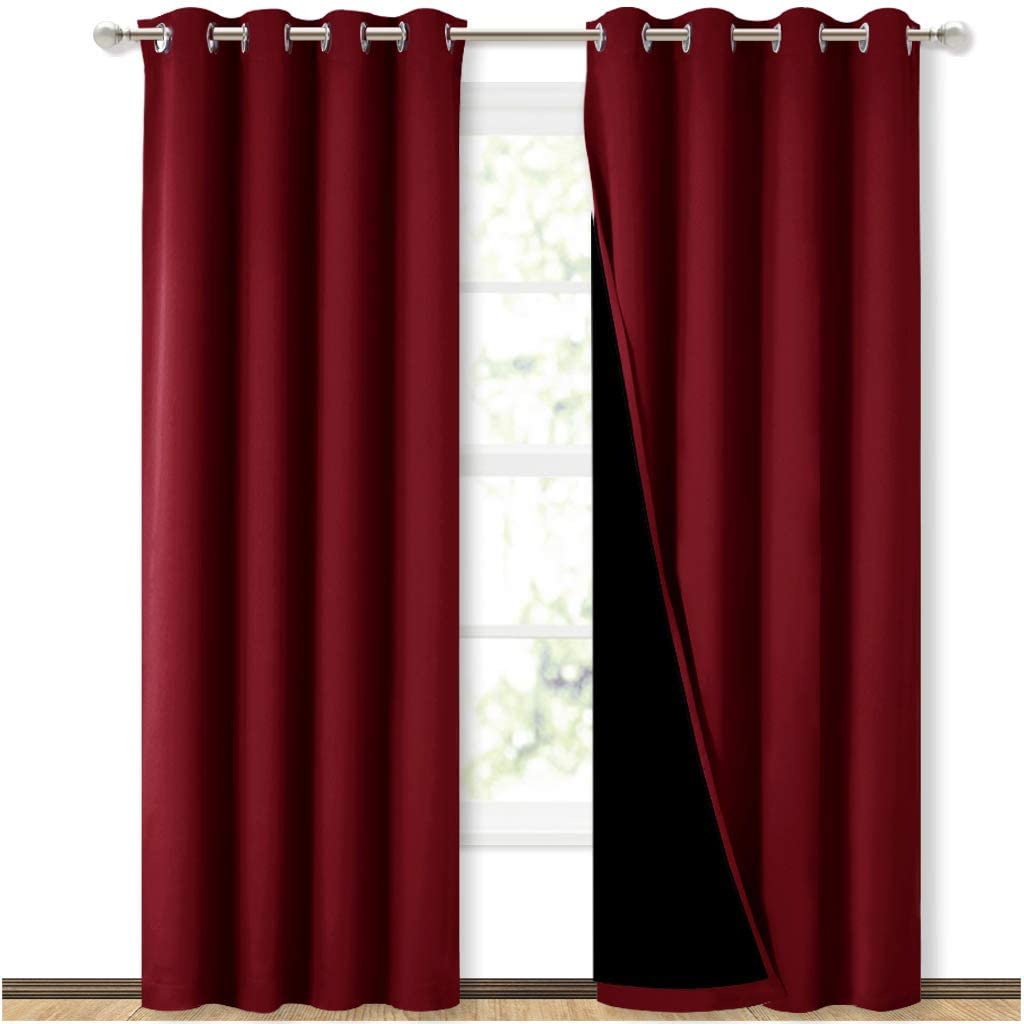 Two red double layer grommet blackout curtains, one revealing its black inner lining, perfect for sliding glass doors.