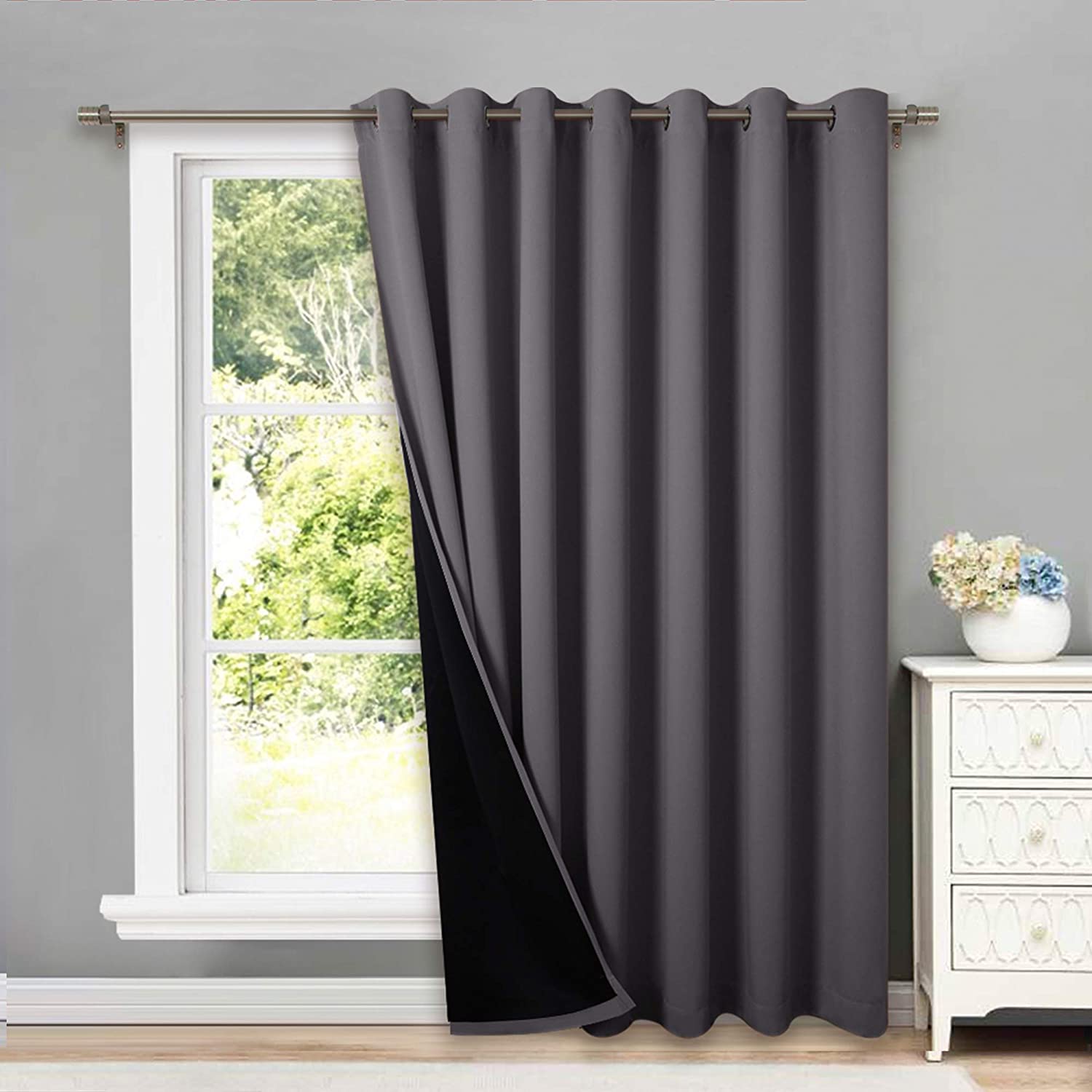 Charcoal double-layer grommet thermal insulated blackout curtain panel, partially open, showing its black lining for full room darkening.